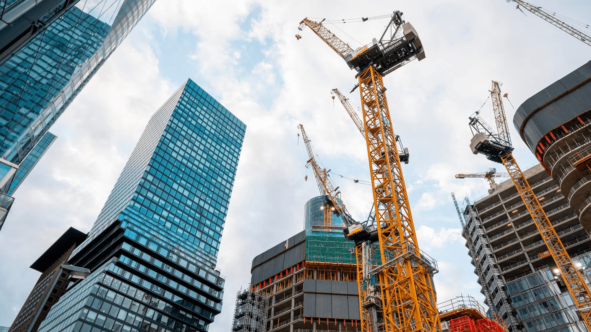 Crane and tower blocks on a large civil construction site at dusk